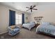 Charming bedroom with two beds, an armchair, and a ceiling fan at 1201 Fantail Dr, Greenwood, IN 46143