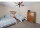 Cozy bedroom with twin beds, ceiling fan, and comfortable carpeting at 1201 Fantail Dr, Greenwood, IN 46143