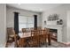 Dining room featuring a wood table, fireplace, and natural light from a large window at 1201 Fantail Dr, Greenwood, IN 46143