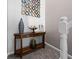 Stylish entryway featuring a decorative table with vases and a unique circular wall decor at 1201 Fantail Dr, Greenwood, IN 46143