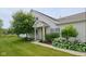 Charming home exterior with lush landscaping, including mature trees and flowering plants at 1201 Fantail Dr, Greenwood, IN 46143