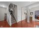 Elegant foyer featuring hardwood floors, staircase with white railing, and decorative accents at 1201 Fantail Dr, Greenwood, IN 46143
