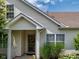 View of a front door with a wreath, covered entry, and manicured landscaping at 1201 Fantail Dr, Greenwood, IN 46143