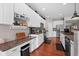 Spacious kitchen featuring white cabinets, stainless steel appliances, and hardwood floors at 1201 Fantail Dr, Greenwood, IN 46143