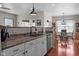 Open kitchen featuring stone countertops, stainless steel appliances, and a view into the dining area at 1201 Fantail Dr, Greenwood, IN 46143