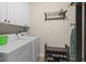 Bright laundry room features white cabinets, modern washer and dryer, and a convenient storage bench at 1201 Fantail Dr, Greenwood, IN 46143