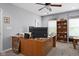 A well-lit home office area showcasing a large desk, fan, and ample storage solutions at 1201 Fantail Dr, Greenwood, IN 46143