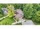 This aerial view features the home's mature trees, brick details and rear patio at 12214 Ridgeside Rd, Indianapolis, IN 46256
