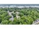 Stunning aerial view of homes surrounded by lush trees near a serene lake and bridge at 12214 Ridgeside Rd, Indianapolis, IN 46256