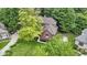 This aerial view captures the house, lush trees, and landscaping at 12214 Ridgeside Rd, Indianapolis, IN 46256