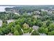 An aerial view showcases the house nestled among lush trees and a nearby lake at 12214 Ridgeside Rd, Indianapolis, IN 46256