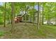 Green backyard view of home's rear exterior and upper deck with outdoor furniture at 12214 Ridgeside Rd, Indianapolis, IN 46256