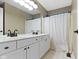 Bathroom with double sinks, white cabinets, and white shower curtain at 12214 Ridgeside Rd, Indianapolis, IN 46256