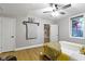Cozy bedroom features a ceiling fan, natural light, and wood-look laminate flooring at 12214 Ridgeside Rd, Indianapolis, IN 46256