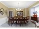 Traditional dining room with wooden table, upholstered chairs, and classic chandelier at 12214 Ridgeside Rd, Indianapolis, IN 46256