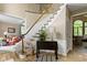 The bright foyer has hardwood floors and a stairway leading to the second level at 12214 Ridgeside Rd, Indianapolis, IN 46256