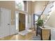 The front foyer has hardwood floors, a large window and a staircase at 12214 Ridgeside Rd, Indianapolis, IN 46256