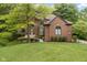 Charming brick home featuring a landscaped yard and inviting entrance at 12214 Ridgeside Rd, Indianapolis, IN 46256