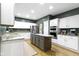 Modern kitchen with white cabinetry, an island, and stainless steel appliances at 12214 Ridgeside Rd, Indianapolis, IN 46256