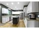 Modern kitchen with stainless steel appliances and a granite island at 12214 Ridgeside Rd, Indianapolis, IN 46256