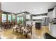 Open floor plan with a fireplace, views of the outside, and hardwood floors at 12214 Ridgeside Rd, Indianapolis, IN 46256