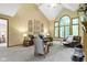 Inviting living room featuring vaulted ceiling, large windows, and comfortable seating at 12214 Ridgeside Rd, Indianapolis, IN 46256
