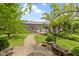 Scenic backyard featuring a brick pathway, mature trees, and a landscaped seating area at 12222 Cable Dr, Indianapolis, IN 46236