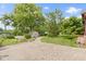 Spacious backyard featuring a brick pathway and a storage shed surrounded by lush greenery and mature trees at 12222 Cable Dr, Indianapolis, IN 46236