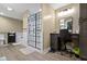 Bright bathroom featuring a tiled shower, soaking tub, vanity area with chair, and modern gray flooring at 12222 Cable Dr, Indianapolis, IN 46236