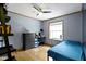 Bedroom features a ceiling fan, a dresser, a desk with computer, a window, and a twin bed with blue bedding at 12222 Cable Dr, Indianapolis, IN 46236