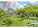 Charming home with a well-manicured front yard featuring lush greenery and colorful flowerbeds at 12222 Cable Dr, Indianapolis, IN 46236