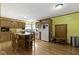 Bright kitchen featuring a center island with seating, white appliances, and wood cabinets at 12222 Cable Dr, Indianapolis, IN 46236