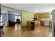Spacious kitchen with center island connecting to the living area, featuring hardwood floors and natural light at 12222 Cable Dr, Indianapolis, IN 46236