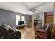 Relaxing living room featuring hardwood floors, a ceiling fan, and built-in shelving and cabinets at 12222 Cable Dr, Indianapolis, IN 46236