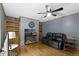 Spacious living room with hardwood flooring, ceiling fan, built-in cabinets, and comfortable seating at 12222 Cable Dr, Indianapolis, IN 46236