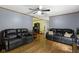 Comfortable living area with hardwood floors, ceiling fan, and two plush leather sofas at 12222 Cable Dr, Indianapolis, IN 46236
