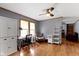 Comfortable home office area featuring natural light, ceiling fan, and hardwood flooring at 12222 Cable Dr, Indianapolis, IN 46236