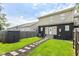 Landscaped backyard features a stepping stone pathway leading up to the house at 1302 Main St, Elwood, IN 46036