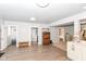Spacious finished basement area with light grey walls, wood floors, and an adjacent laundry room at 1302 Main St, Elwood, IN 46036