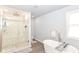 Bathroom featuring tiled shower, soaking tub, and modern finishes for a spa-like experience at 1302 Main St, Elwood, IN 46036