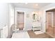 Modern bathroom featuring a soaking tub, vanity with storage, and access to a spacious walk-in closet at 1302 Main St, Elwood, IN 46036