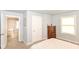 Bright bedroom showcases a well-lit space, complemented by carpet and neutral walls at 1302 Main St, Elwood, IN 46036