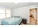 A sunlit bedroom offers a calming space with neutral walls and plush carpeting at 1302 Main St, Elwood, IN 46036
