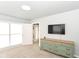 Well-lit bedroom with a vintage dresser, flat screen television, and access to an ensuite at 1302 Main St, Elwood, IN 46036