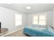 Cozy bedroom featuring neutral walls, plush carpeting, and two windows for a bright, inviting space at 1302 Main St, Elwood, IN 46036