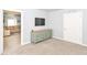 Cozy bedroom with a light green dresser, view into the living room, and light blue walls at 1302 Main St, Elwood, IN 46036