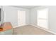 Bedroom with carpeted floors, flat screen television, vintage green dresser, and lots of natural light at 1302 Main St, Elwood, IN 46036
