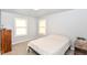 Bedroom with carpeted floor and light-filled windows creating a bright and airy atmosphere at 1302 Main St, Elwood, IN 46036