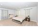 Well-lit bedroom boasts neutral walls, plush carpeting, and patterned curtains for a serene retreat at 1302 Main St, Elwood, IN 46036