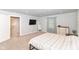 Spacious bedroom features soft carpeting, large TV, walk-in closet, and large windows for a bright space at 1302 Main St, Elwood, IN 46036